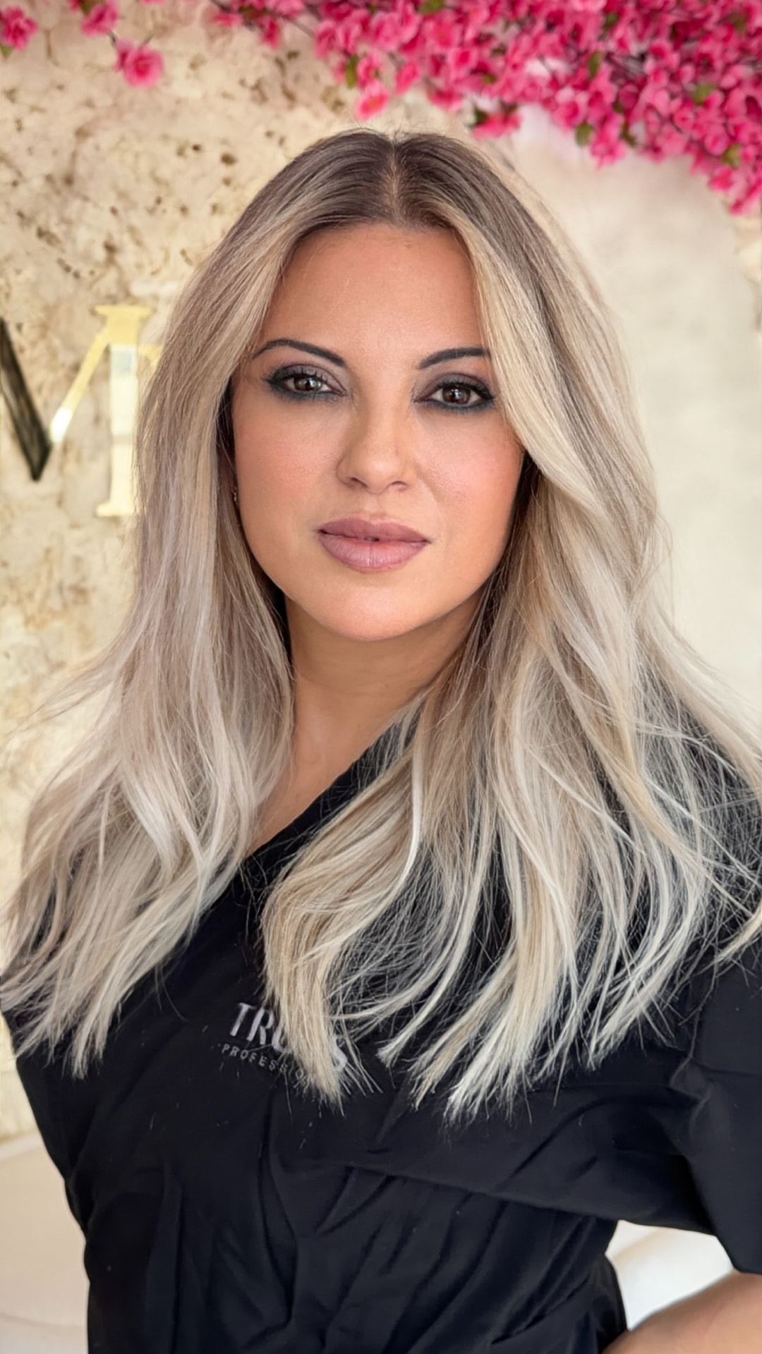 Icy blonde with a shadow root and soft waves